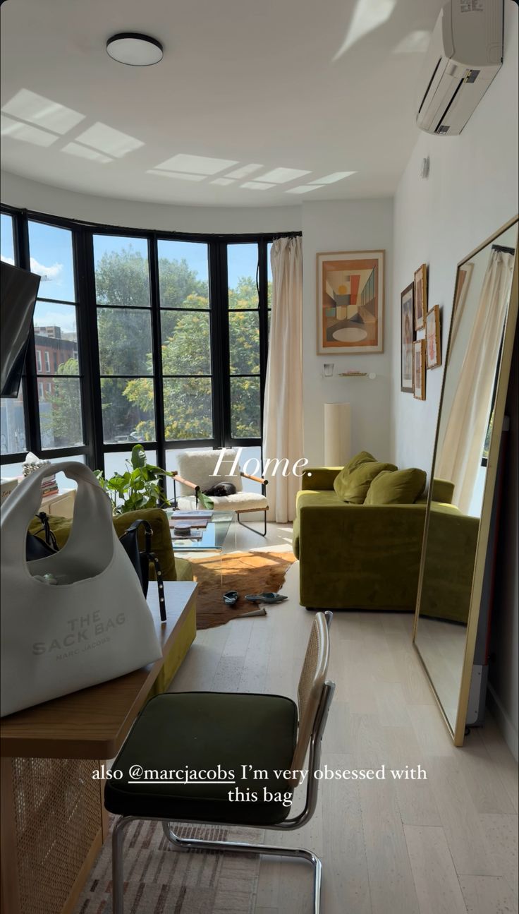 a living room filled with furniture and large windows