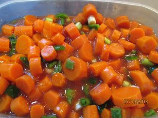 carrots and celery are being cooked in a pan