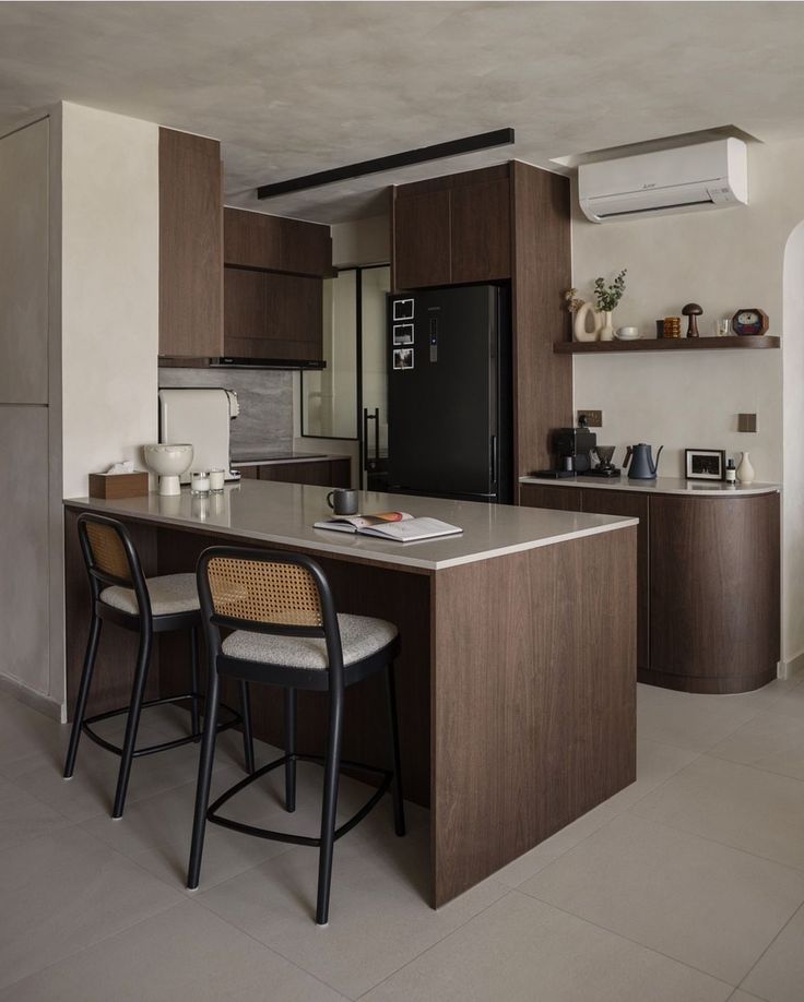 a kitchen with two stools and an island