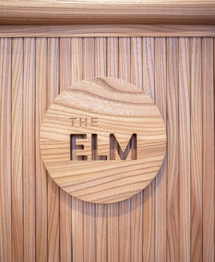 a wooden door with the word the elm carved into it