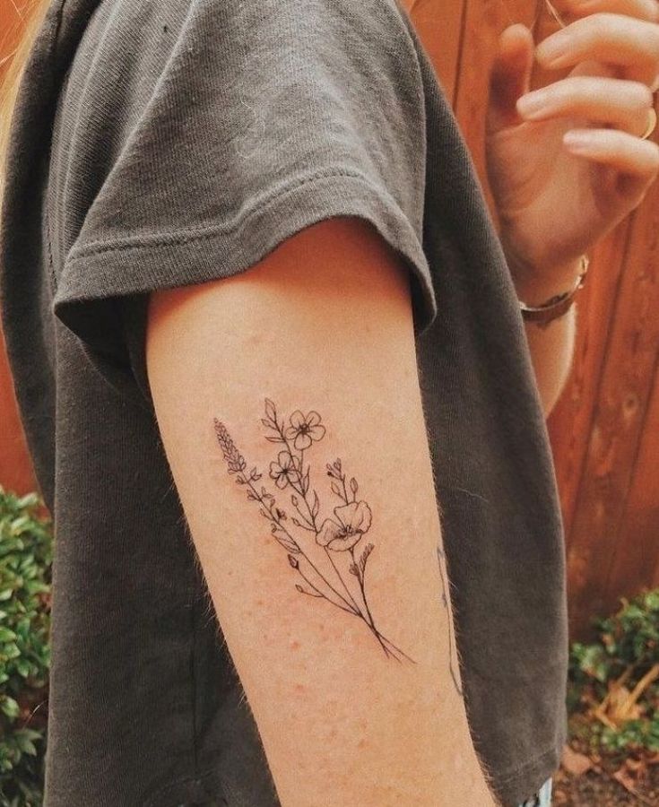 a person with a flower tattoo on their arm