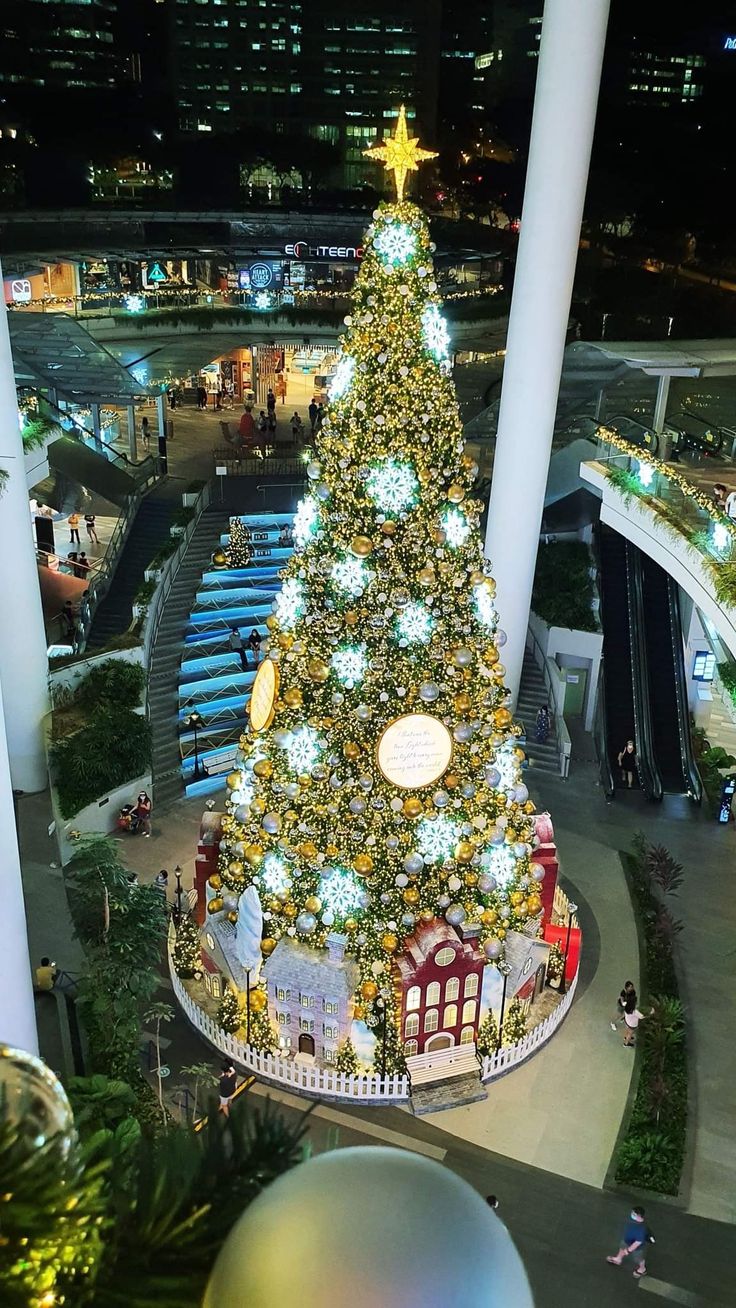 a large christmas tree in the middle of a mall