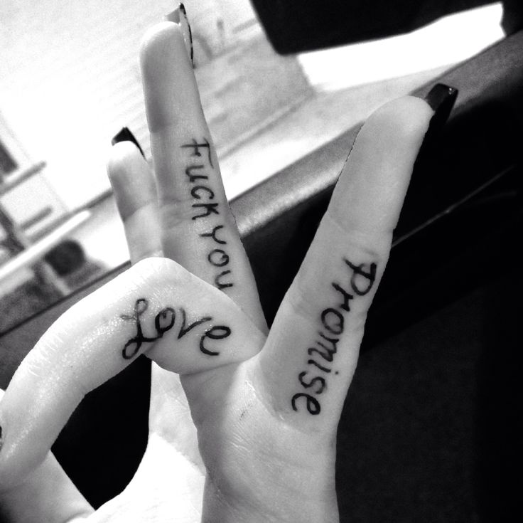 two fingers with words written on them in the shape of heart and hand gesture signs