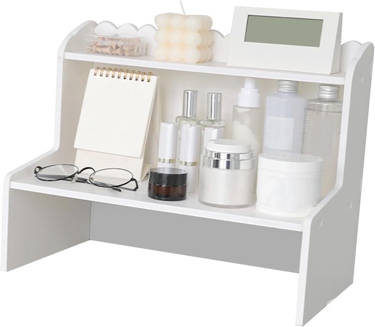 a white shelf with various items on top of it and a notepad next to it