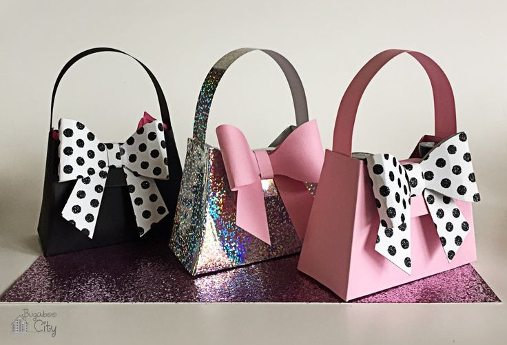 three small bags with bows on them