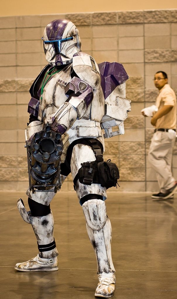 a man dressed as a storm trooper standing in an indoor area