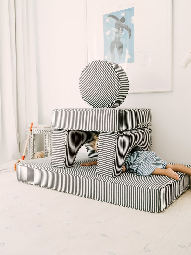 a child laying on top of a bed made out of blocks