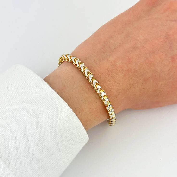 "Elevate your style with this exquisite 5mm Solid 14k Gold Franco Diamond Cut Chain Bracelet. Crafted in Italy from high-quality 14k gold, this bracelet features a unique two-tone prism gold design that adds a touch of elegance and sophistication. The diamond cut detailing on the Franco chain enhances its sparkle and shine, making it a standout piece of jewelry. The 5mm width gives it a substantial and bold look, perfect for making a statement. The sturdy lobster clasp provides secure closure, e Elegant Cuban Link Chain Bracelet With Diamond Cut, Gold Tennis Bracelet With Prong Setting For Everyday Wear, Elegant Diamond Cut Cuban Link Chain Bracelet, Elegant Cuban Link Diamond Cut Bracelets, Elegant Diamond Cut Cuban Link Bracelet Gift, Elegant White Cuban Link Bracelets, Gold Tennis Bracelet With Diamond Cut For Everyday Wear, Gold Diamond Cut Tennis Bracelet For Everyday, Modern Gold Tennis Bracelet With Diamond Cut