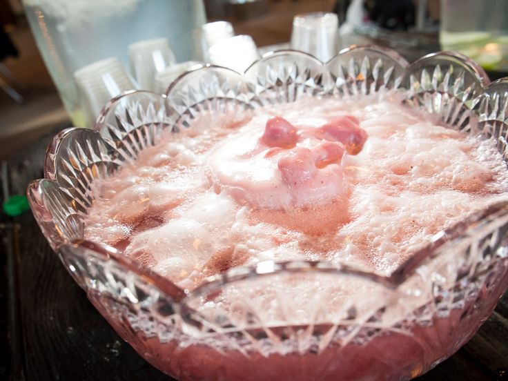 a glass bowl filled with liquid on top of a table