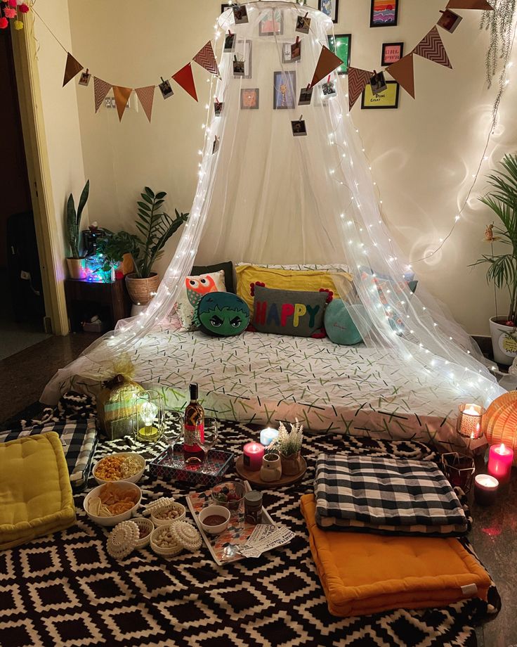 a bed with lots of pillows and blankets on it in a room decorated for halloween