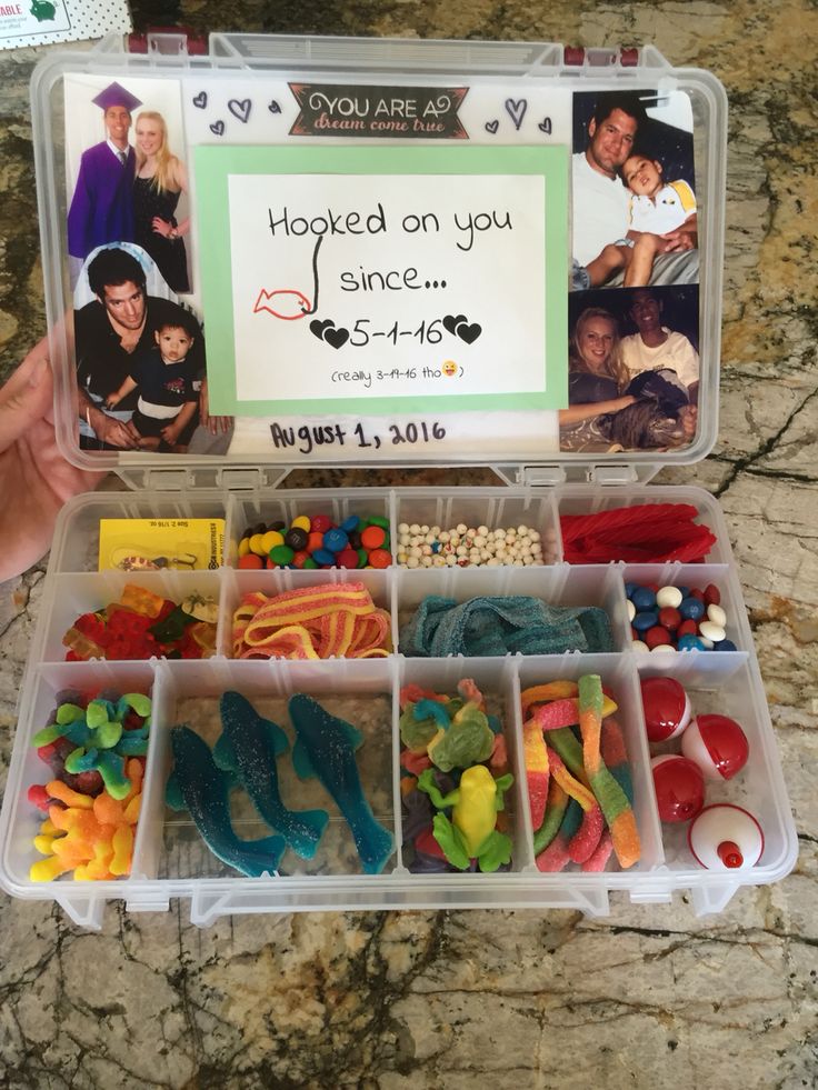 a plastic container filled with lots of candy and candies next to a sign that says i hooked on you since