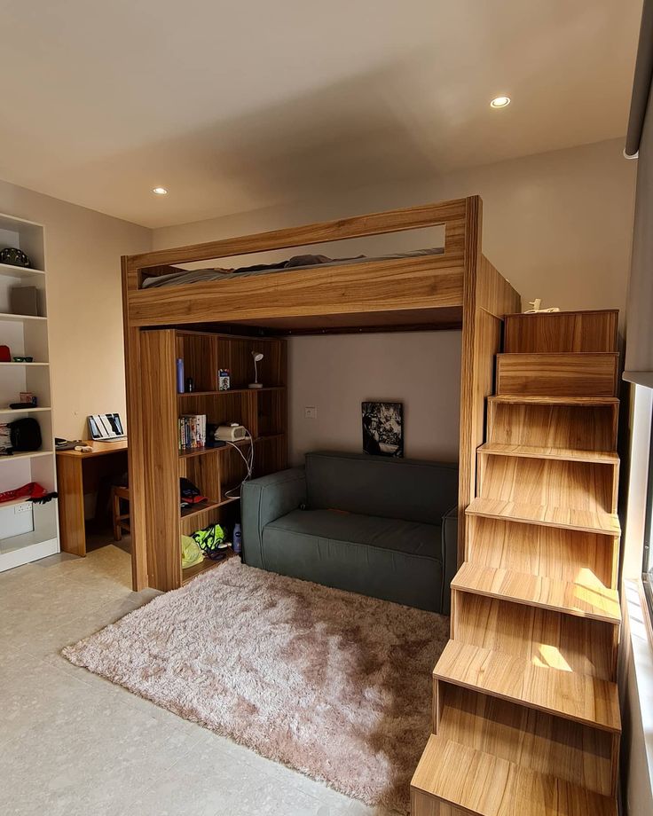 there is a loft bed in the middle of this living room with stairs leading up to it