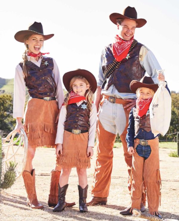 three children and an adult are dressed up in western attire for the day at the ranch