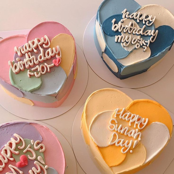 four heart shaped cakes with happy birthday messages on them