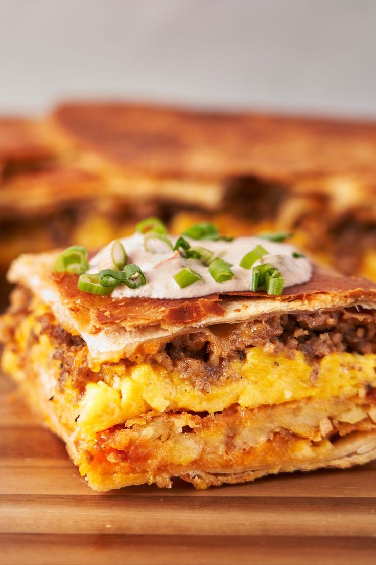 a stack of food sitting on top of a wooden cutting board