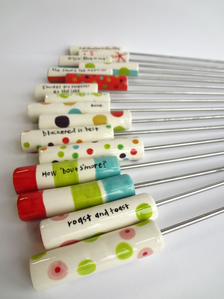 several colorful toothbrushes with writing on them sitting next to some metal straws