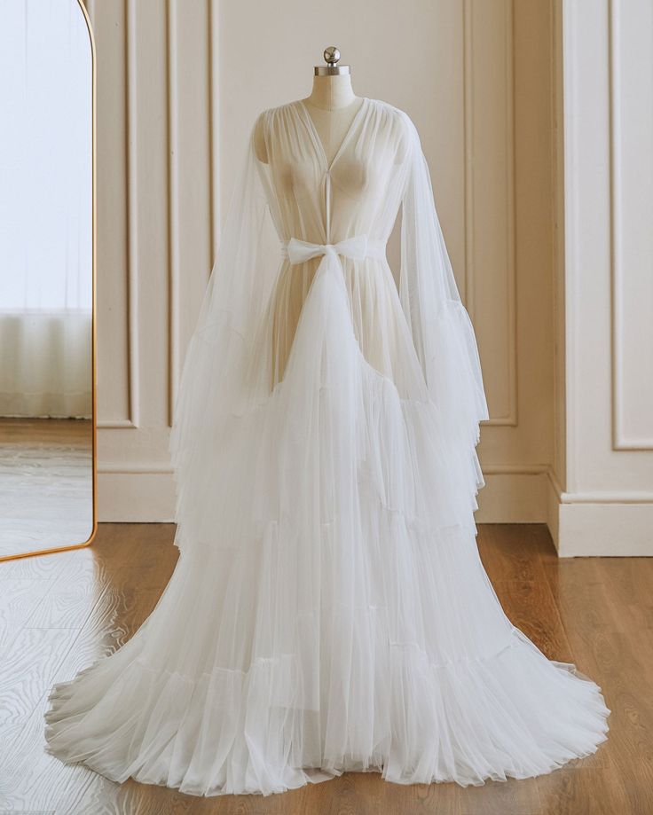 Ivory Tulle Robe with Ruffles RR2202 Ethereal Tulle Wedding Gown, White Ruffled Wedding Gown, White Tulle Maternity Gown, Floor-length Ruffled Gown For Wedding, Wedding Tulle Fabric With Ruffles, Ruffled Tulle Fabric For Wedding, White Ruffled Gown For Wedding Night, White Tulle Gown With Ruffles, Maternity Tulle Gown With Ruffles