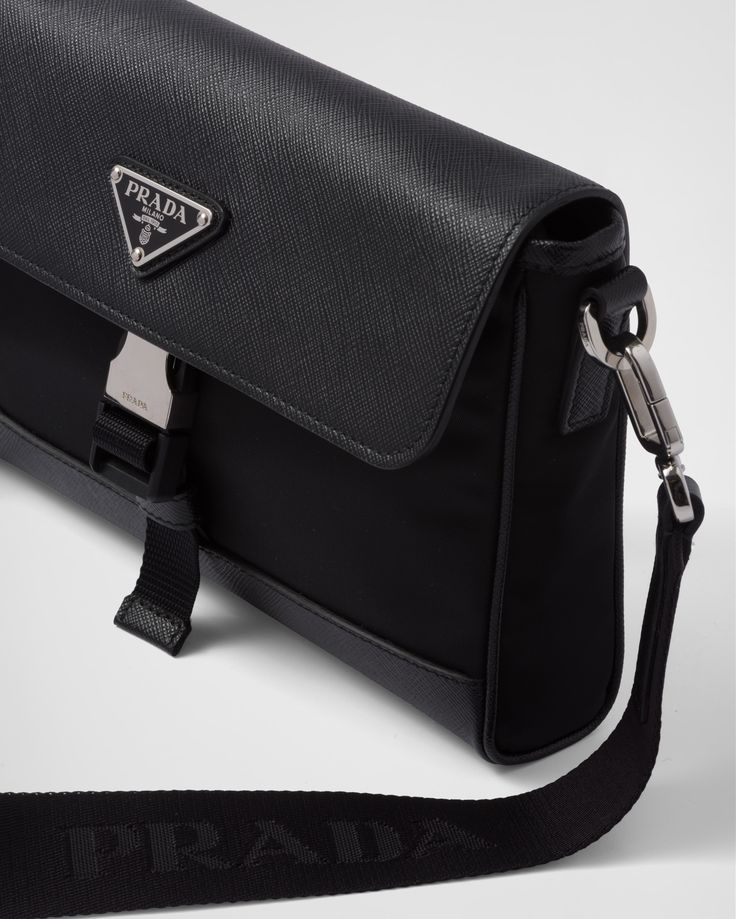 Detachable, adjustable nylon webbing and leather shoulder strap Enameled-metal triangle logo on flap Fastening with flap and push-lock clasp Interior with patch pocket Re-Nylon logo lining Prada Bag Men, Shoulder Bag Prada, Prada Runway, Bag Prada, Brand Icon, Mens Travel, Prada Bags, Triangle Logo, Leather Accents