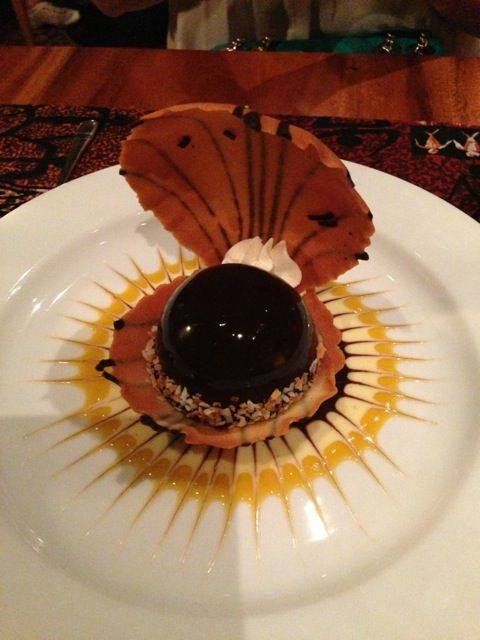 a white plate topped with a dessert covered in chocolate