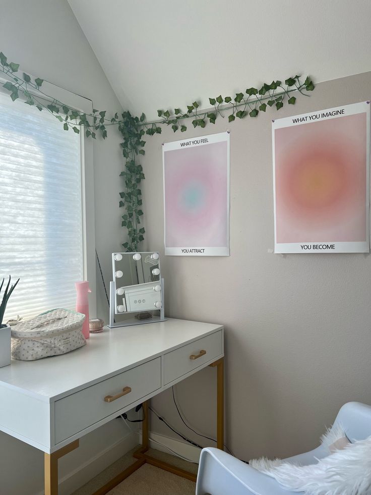 a white desk with two pictures on the wall