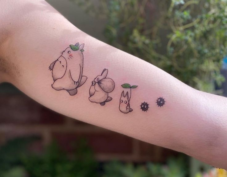 a person with a tattoo on their arm that has animals and flowers all over it