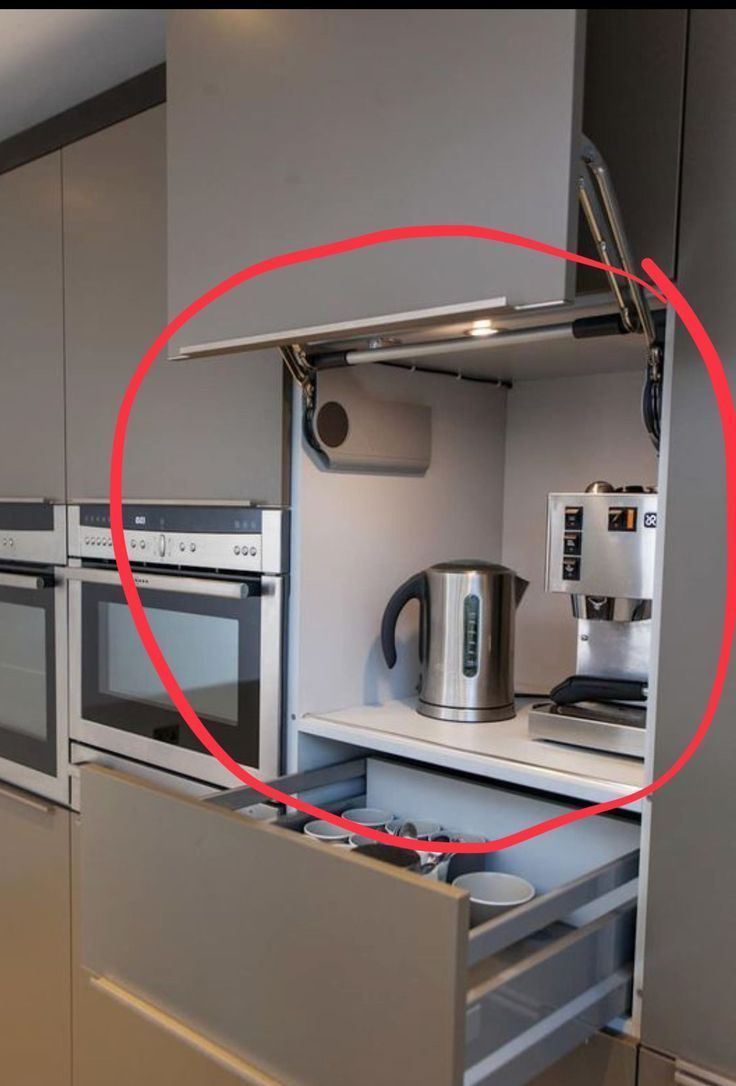 a kitchen with stainless steel appliances and an oval red marker pointing to the oven door