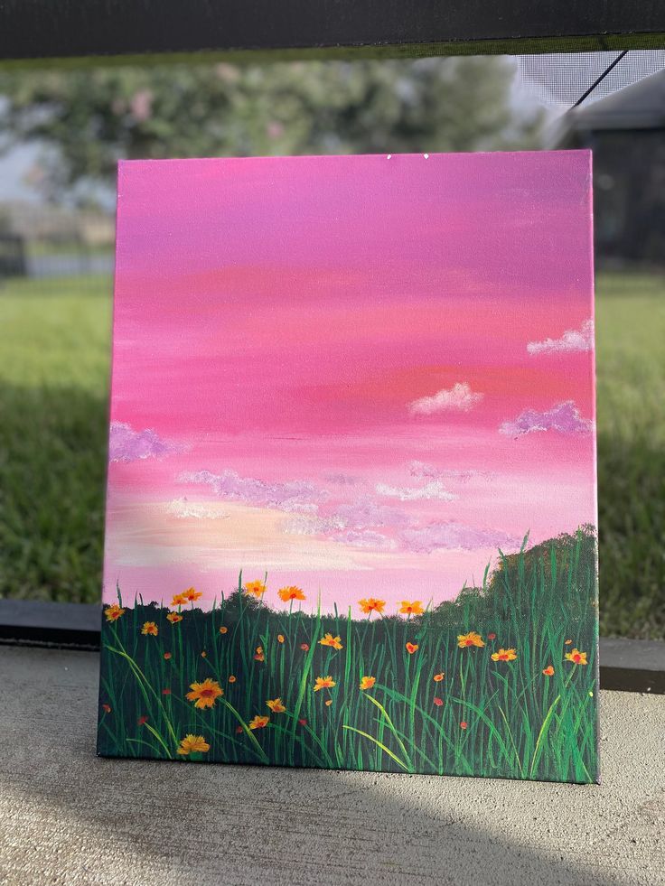 an acrylic painting of grass and flowers in front of a pink sky with clouds