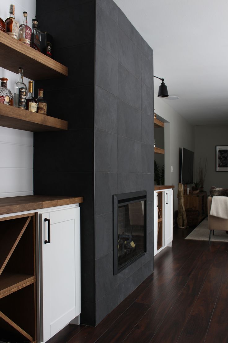 a living room filled with furniture and a fire place next to a wall mounted tv