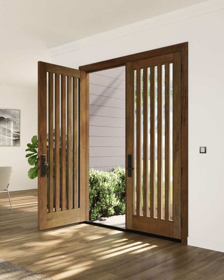 an open wooden door in a white room with wood flooring and blinds on the sliding glass doors