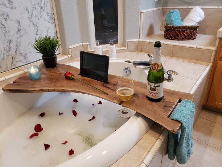 a bathtub with rose petals and wine in it