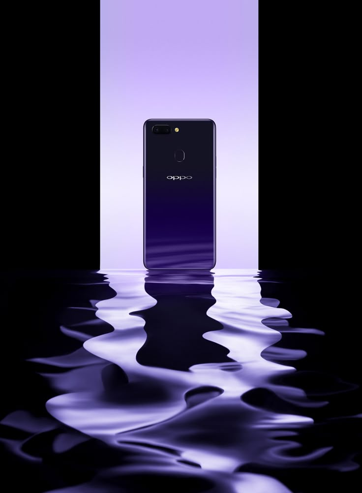 an image of a purple cell phone in the water with ripples on the surface