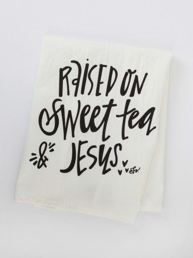 a white tea towel with the words raised on sweet tea and jesus printed on it