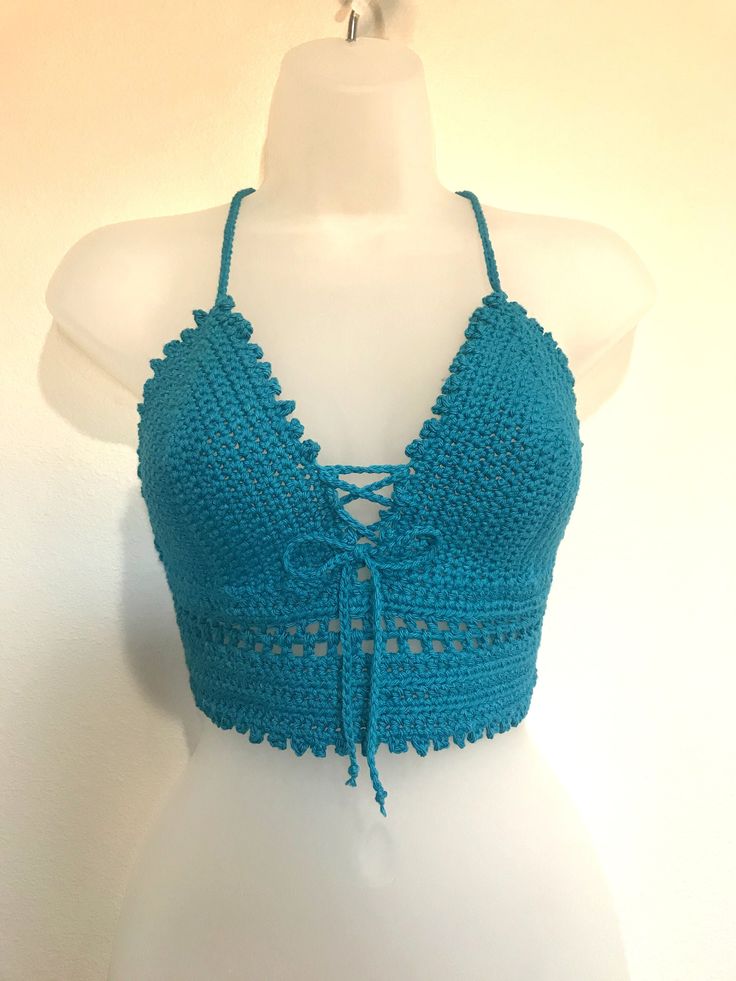 -Hand crocheted summer/festival Crop Top -Made with I Love This Cotton Yarn -Adjustable corset style back and adjustable string in the front that can also be removed if desired.  -Best to hand wash so the colors will not fade as fast. Use a mixture of cold water and white vinegar to set the color in.  -Color will fade over time and top will slightly shrink after the first wash Handmade Fitted Crochet Top For Festival, Crochet Lace Top For Summer Beach Party, Blue Lace Crochet Top For Summer, Fitted Lace Crochet Top For Beach, Blue Crop Top With Adjustable Straps For Beach, Blue Beach Crop Top With Adjustable Straps, Blue Adjustable Straps Crop Top For Beach, Strappy Tie Back Tops For Beach, Handmade Lace Crochet Top For Summer