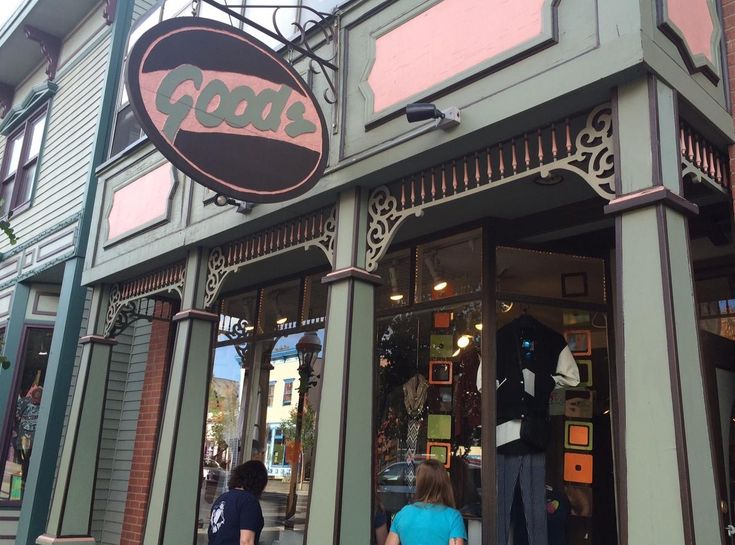 two people walking in front of a clothing store