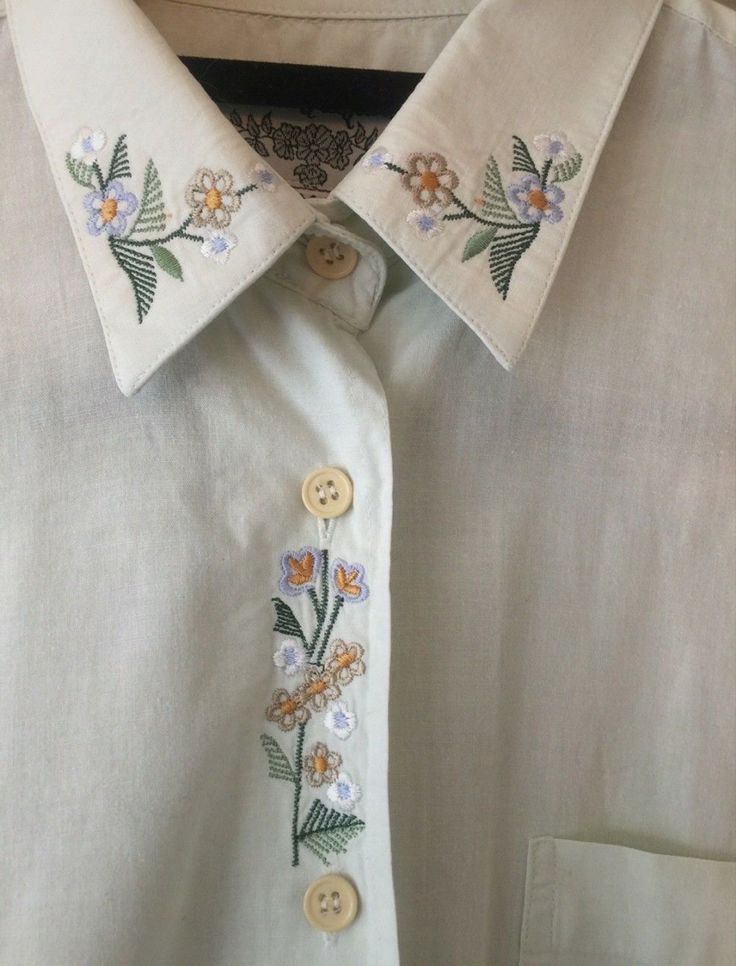 a white shirt with flowers on the collar