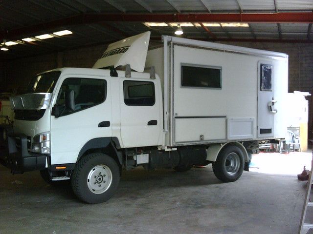 a white truck parked inside of a garage