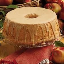 a cake sitting on top of a table covered in apples