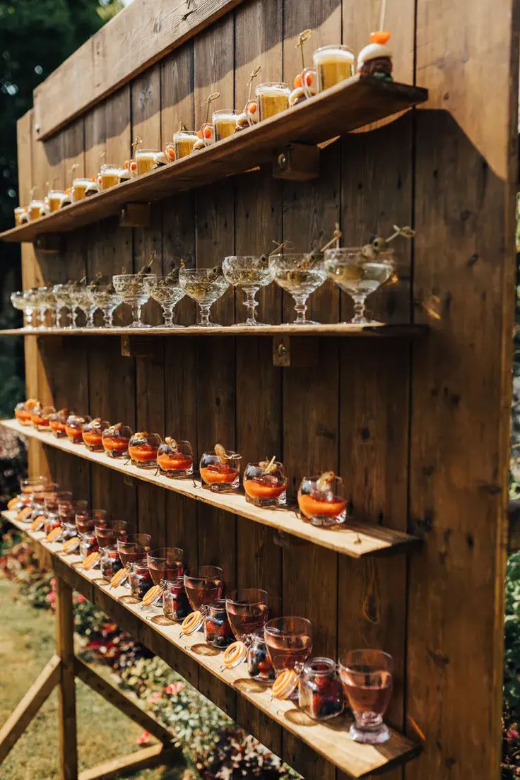 a wooden shelf filled with lots of glasses