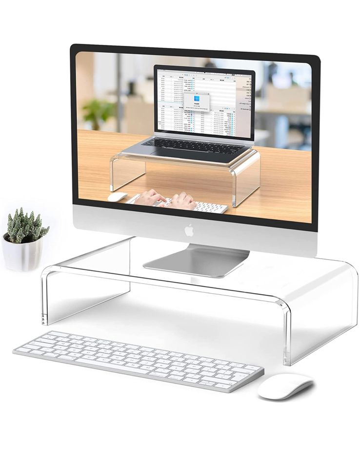 a computer monitor sitting on top of a wooden desk next to a keyboard and mouse