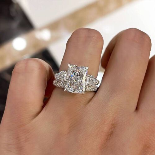 a woman's hand with a diamond ring on her left and an engagement ring on the right