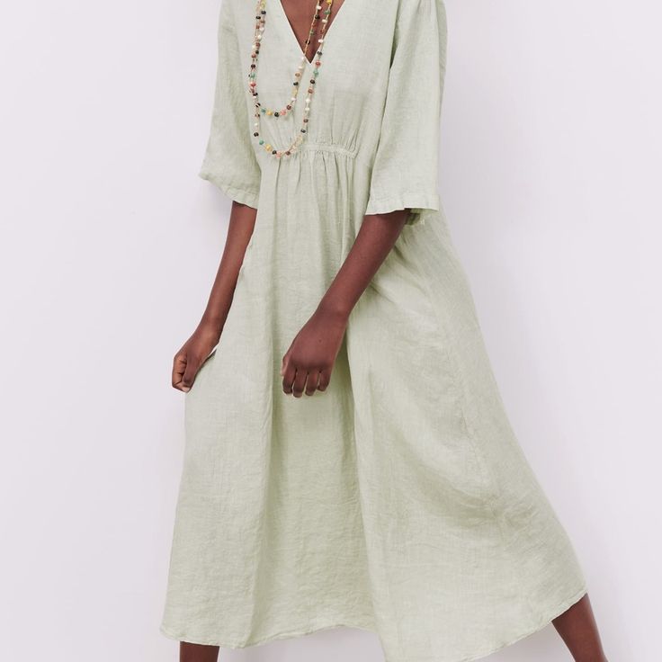 Long Dress Made Of 100% Linen. V-Neck And Short Sleeves. Front Ruched Elastic Details. Color - Sea Green Spring V-neck Linen Dress For Brunch, Casual V-neck Linen Dress For Brunch, Relaxed Fit V-neck Midi Dress For Beach, Relaxed Fit V-neck Midi Dress, Flowy Linen V-neck Dress, Spring Daywear V-neck Split Neck Dress, Bohemian V-neck Relaxed Dress, V-neck Linen Dress For Spring Daywear, Casual Linen V-neck Dress For Brunch