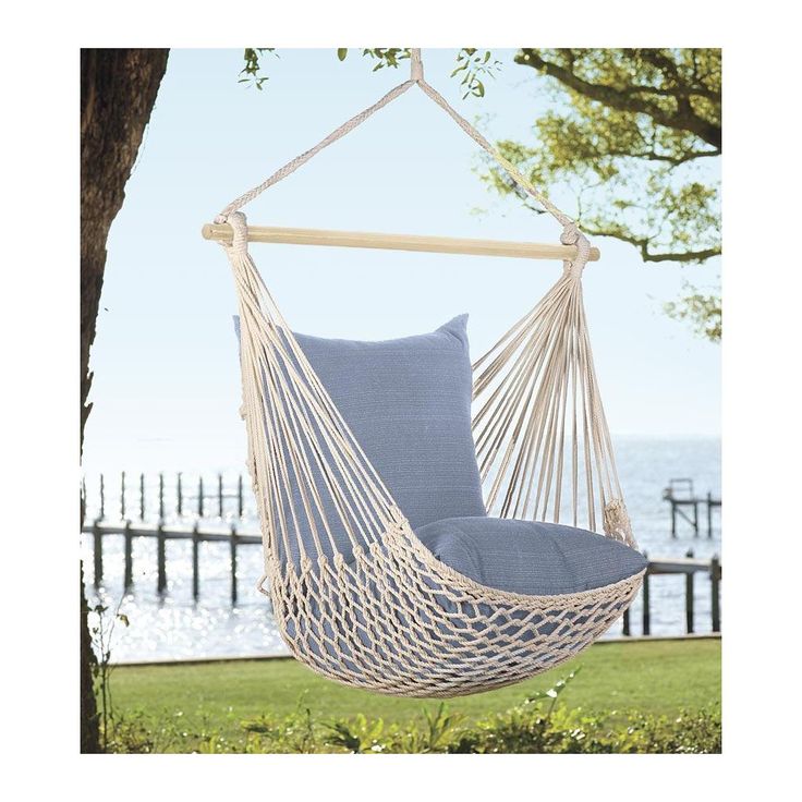 a blue hammock chair hanging from a tree