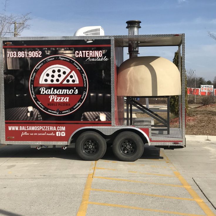 a pizza delivery truck parked in a parking lot