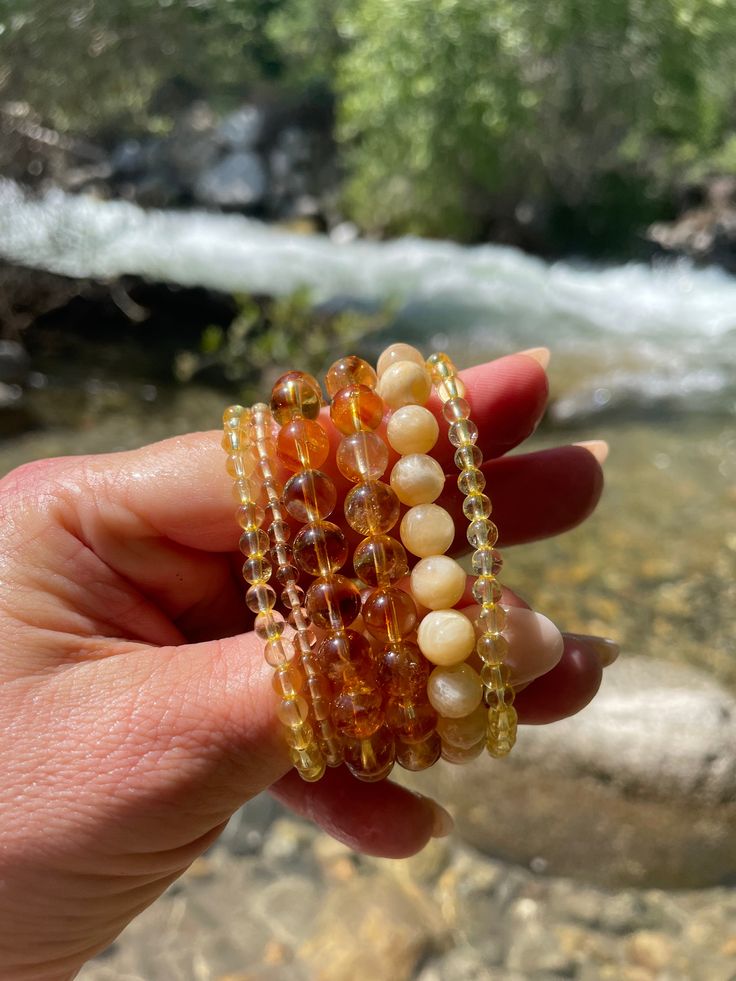 Natural citrine is excellent for encouraging motivation, drive, and abundance of any kind. I use it in my practice when meditation for motivation is needed. It is a powerful cleanser of the chakras, especially the solar plexus. It is a truly generous stone of abundance and teaches us to manifest loudly so that confidence remains and hard work is viewed with optimism as we attain current goals and work towards new ones. If you are particularly sensitive to outside influence and tend to "take on" Amber Citrine Beaded Bracelets As A Gift, Amber Citrine Beaded Bracelet As A Gift, Amber Citrine Crystal Bracelet As A Gift, Spiritual Amber Beaded Bracelets With Gemstone Beads, Spiritual Amber Crystal Bracelet With Gemstone, Amber Beaded Bracelets For Meditation, Spiritual Amber Beaded Bracelets, Spiritual Amber Gemstone Beaded Bracelets, Amber Round Beads Bracelet For Meditation