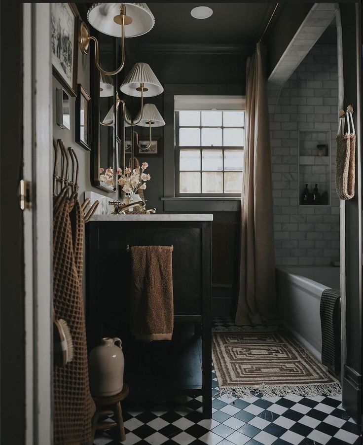 a black and white checkered floor in a bathroom next to a sink with mirrors on the wall