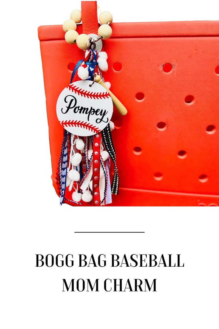 a baseball mom charm hanging from a red wall with the words pompey on it