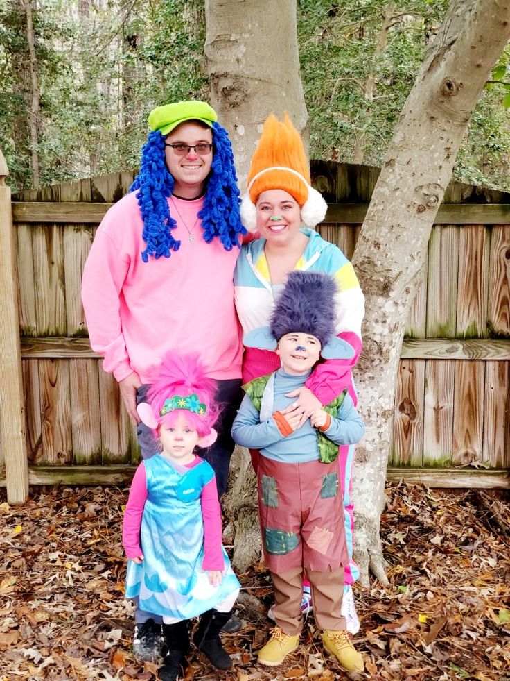 two adults and one child dressed up in costumes