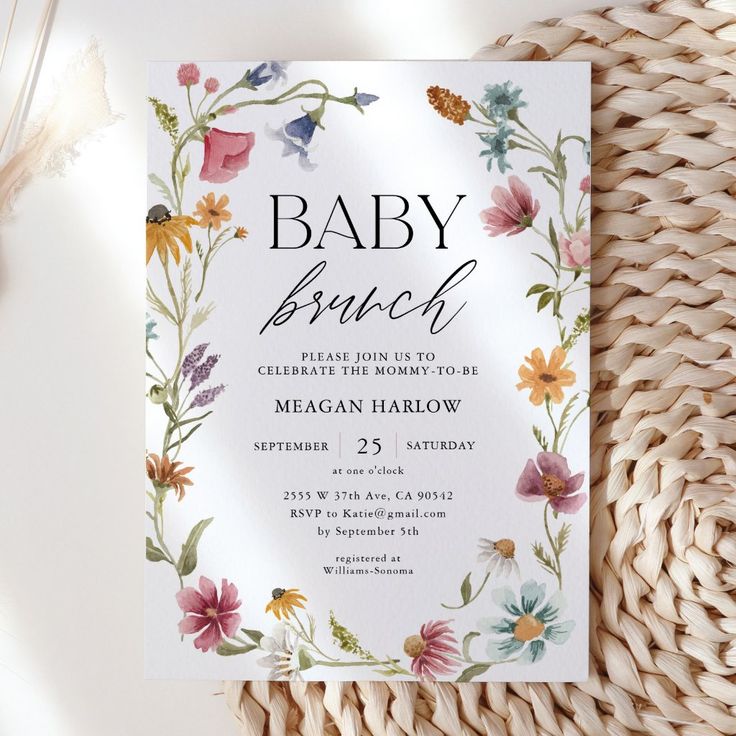 a baby brunch is on the table next to a wicker basket and flowers