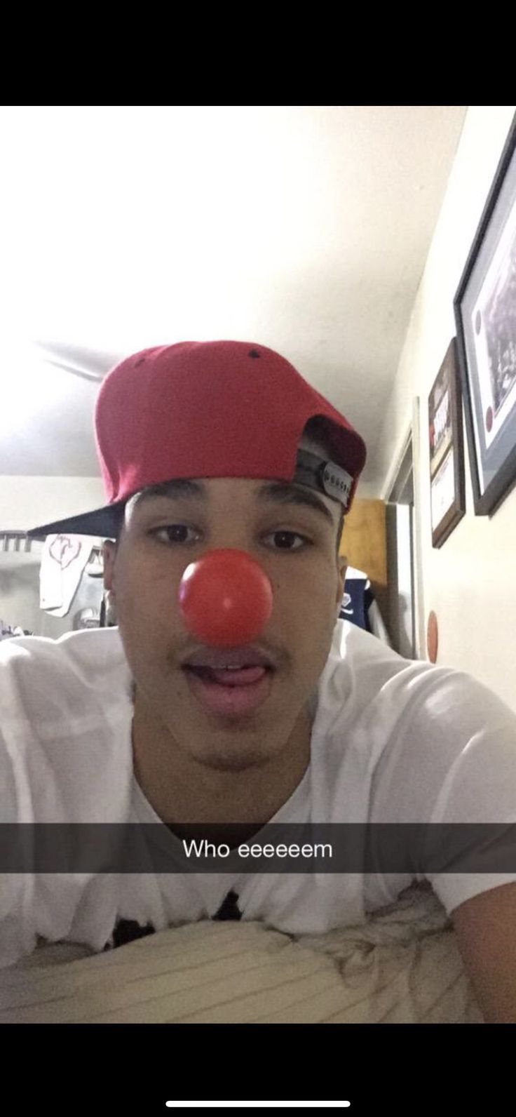 a man with a red nose wearing a hat