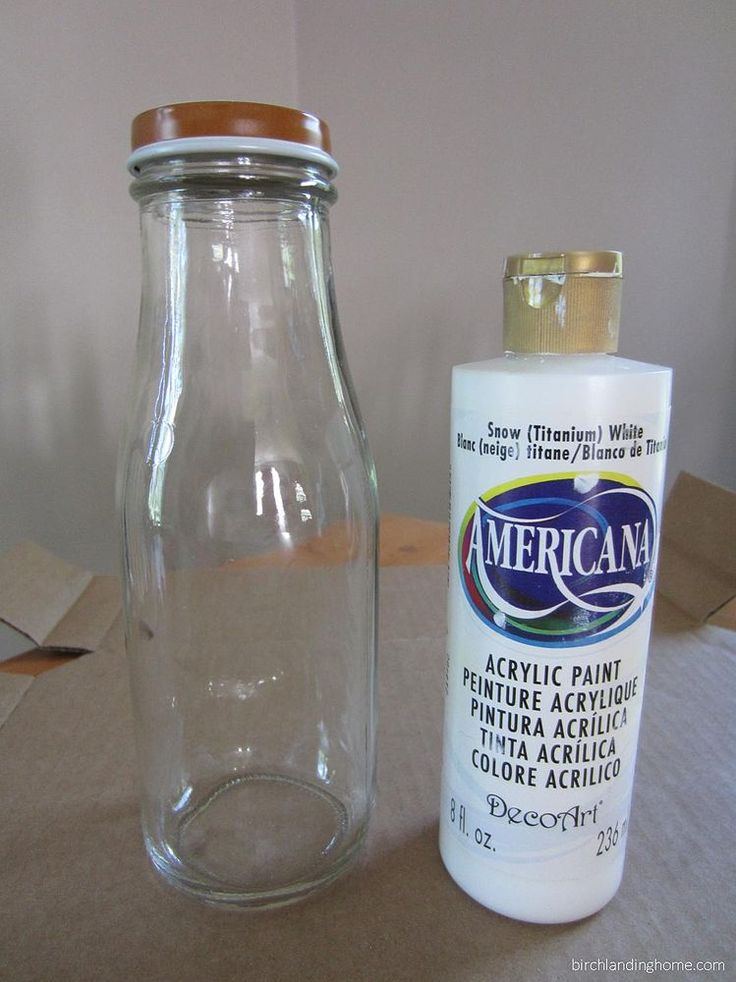 an empty glass bottle next to a clear jar